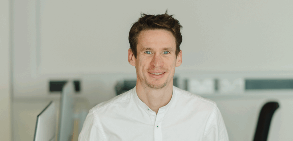 Head shot of LeftBrain CEO, Charlie Naughton-Rumbo smiling into camera taken from the podcast about career change into cyber security.