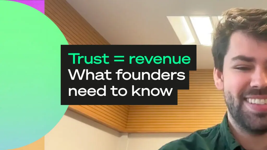 Smiling speaker on a video call, with a text overlay reading “Trust = revenue. What founders need to know” on a dark panel beside the face.
