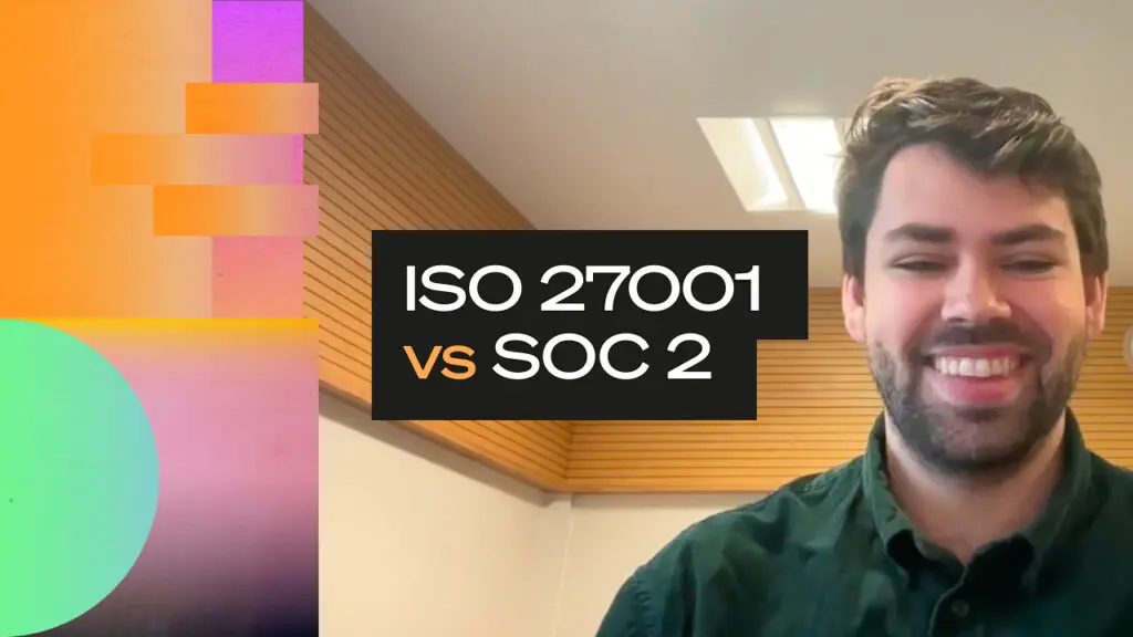 Smiling person on a video call in an office setting, with bold overlay text reading “ISO 27001 versus SOC 2” alongside abstract gradient shapes.