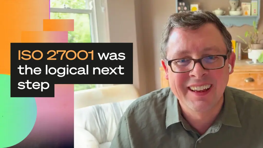 Person on a video call smiling in a home office, with bold overlay text reading “ISO 27001 was the logical next step” against a colourful gradient background.